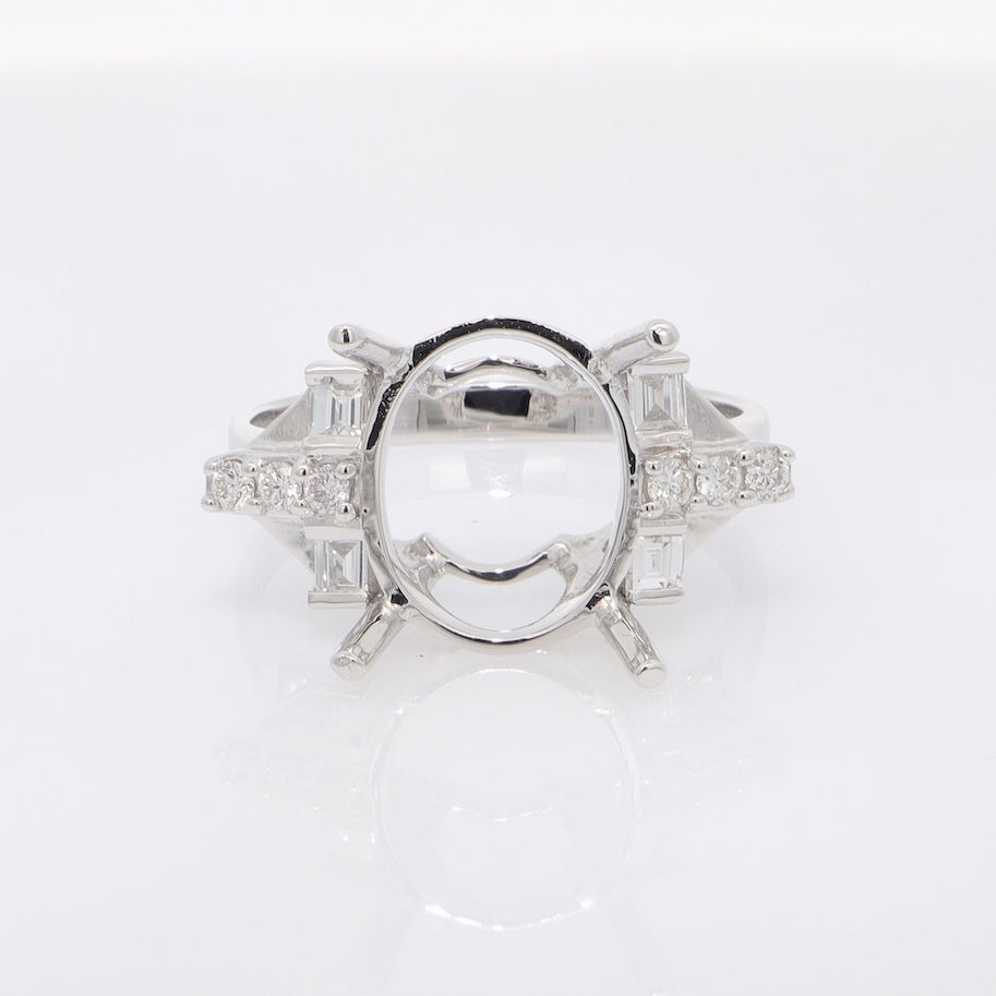 Vintage-style oval diamond engagement ring setting with mixed-cut baguette and pavé accents.