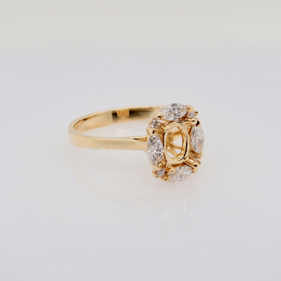 Thumbnail: Vintage floral diamond engagement ring setting with marquise and round diamond halo in gold.