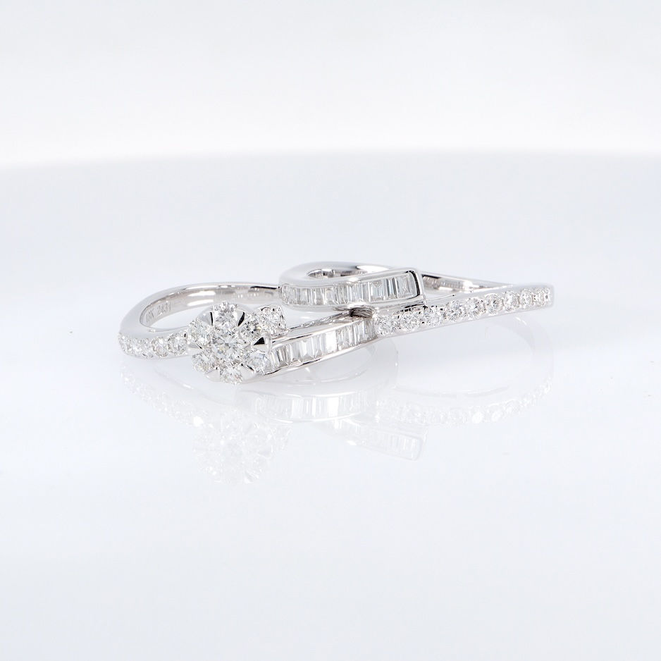 Gold diamond bypass band ring with round brilliant and baguette cut diamonds