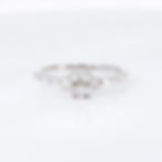 Modern geometric diamond ring with a plus-shaped baguette diamond cluster in fine gold.