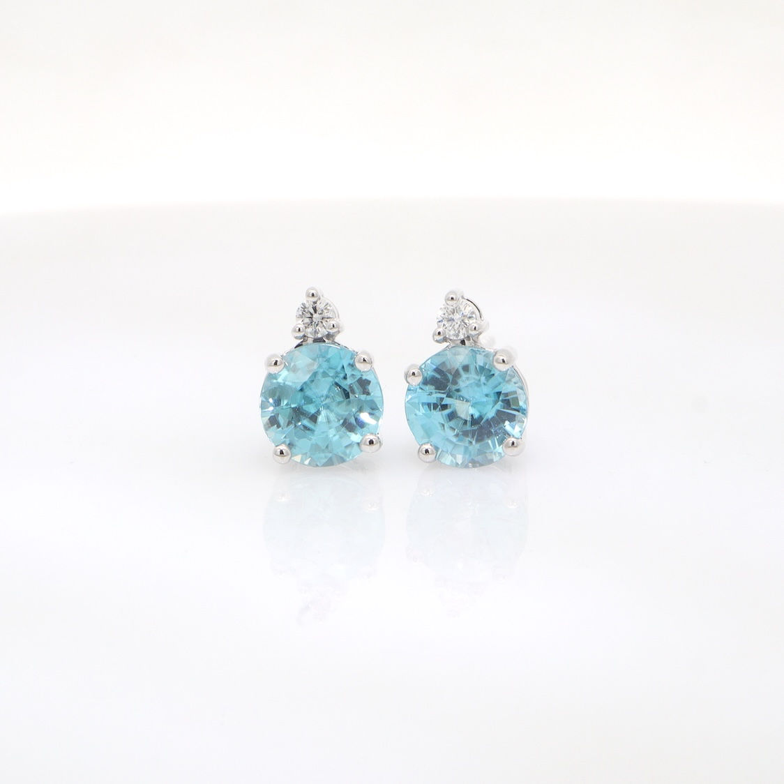 Round gemstone and diamond stud earrings in fine gold