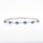 Oval gemstone and diamond bracelet in fine gold prong setting