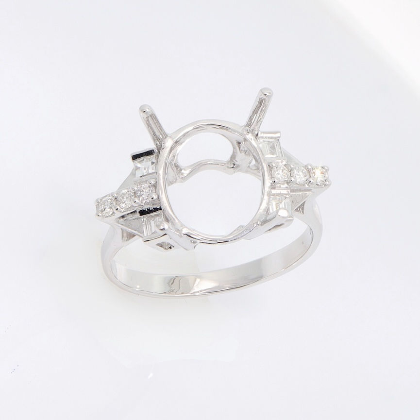 Vintage-style oval diamond engagement ring setting with mixed-cut baguette and pavé accents.