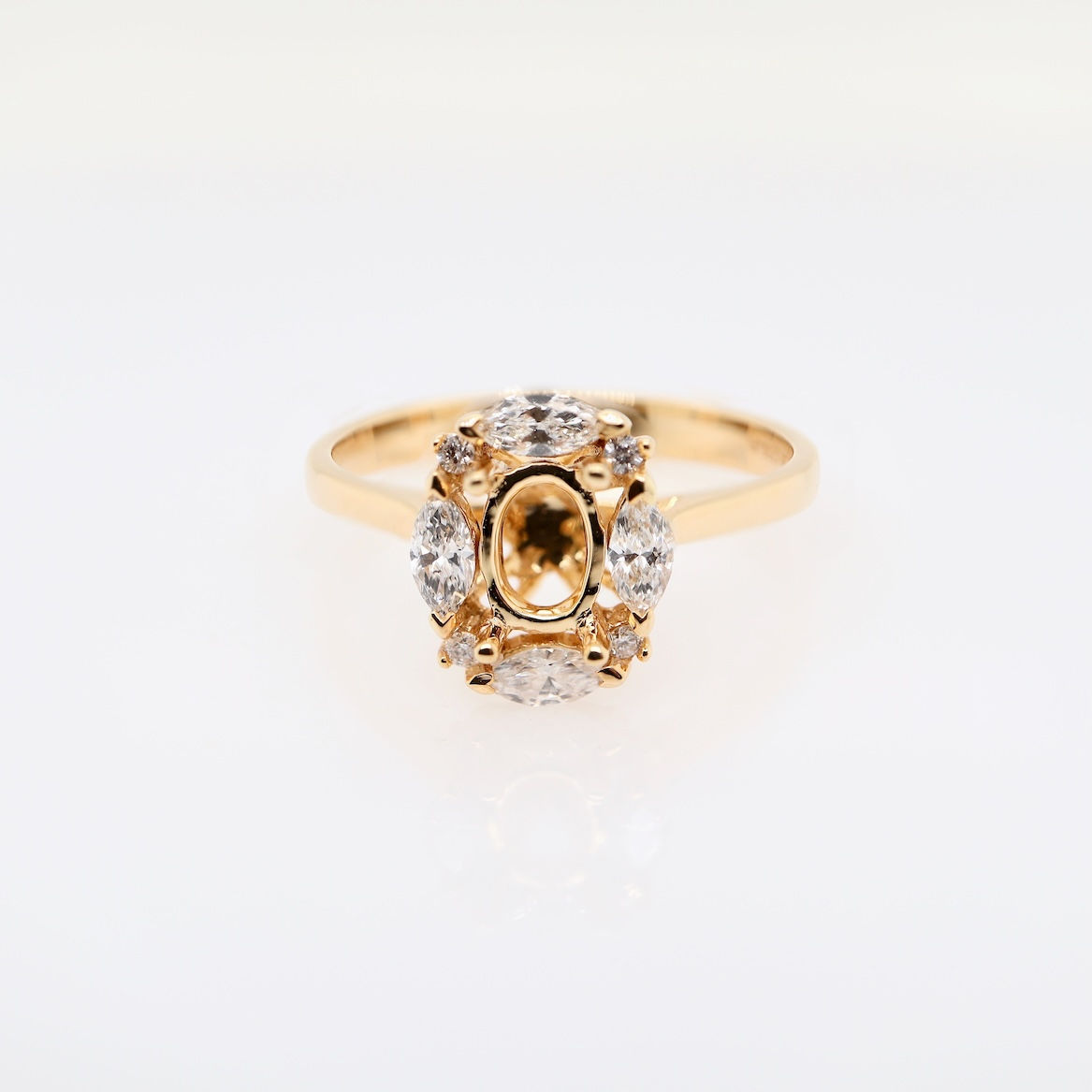 Vintage floral diamond engagement ring setting with marquise and round diamond halo in gold.