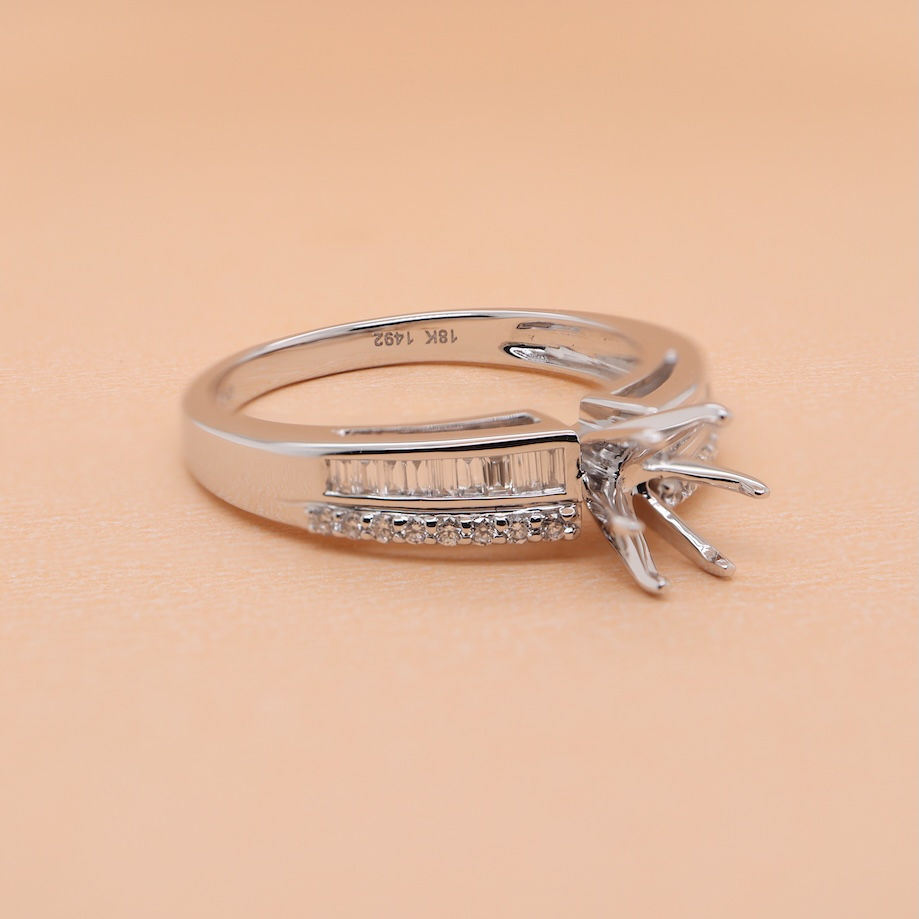 Thumbnail: Gold solitaire diamond ring with round and baguette diamonds