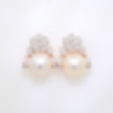 Floral pearl and diamond earrings with pavé diamond flower studs and lustrous pearls in fine gold.