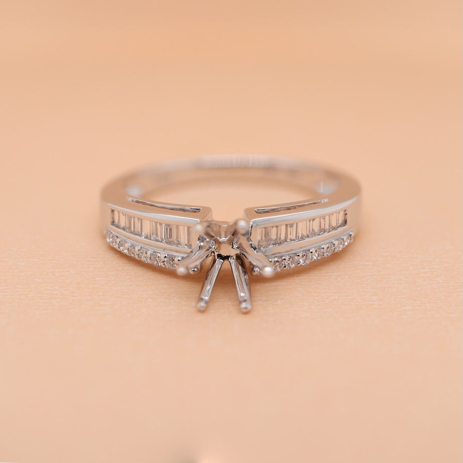 Thumbnail: Gold solitaire diamond ring with round and baguette diamonds