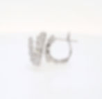 Modern snake diamond earrings in a huggie hoop style with pavé diamond details in fine gold.