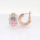 Channel-set gemstone hoop earrings with pavé diamond rows in fine gold. Custom fine jewelry.