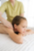 closeup-vertical-shot-pretty-girl-having-neck-shoulder-back-massage-by-unrecognizable-fema