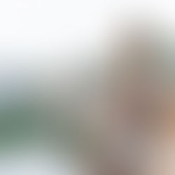 Woman standing still overlooking a river, representing feeling stuck in life and finding alignment during a transition