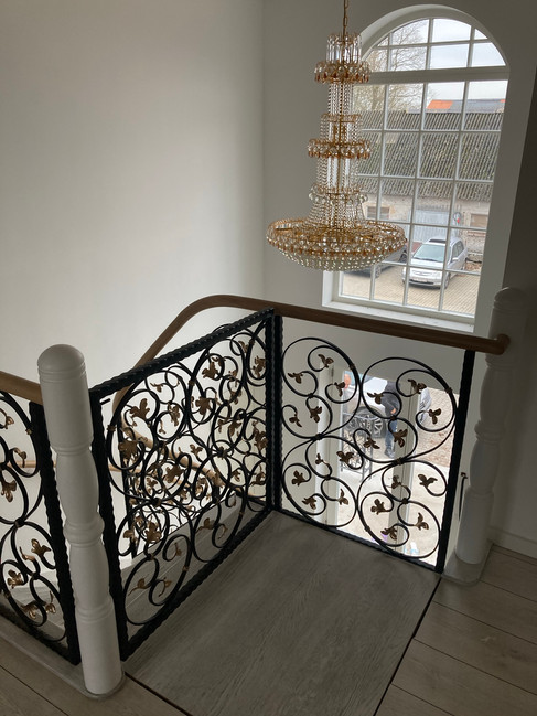 Stairs with custom blacksmith railings.