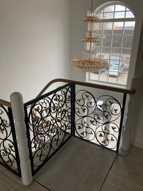 Stairs with custom blacksmith railings.