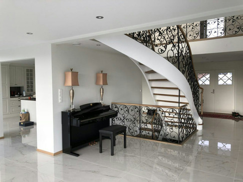 Solid construction staircase with blacksmith railings.