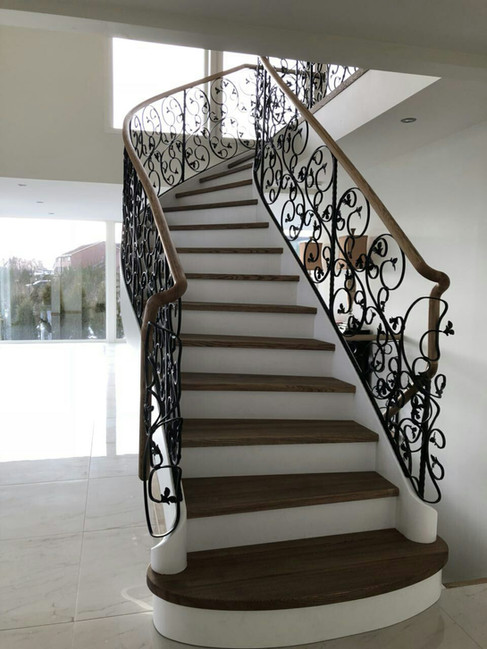 Solid construction staircase with blacksmith railings.
