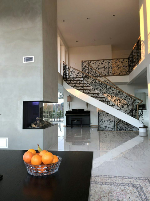 Solid construction staircase with blacksmith railings.