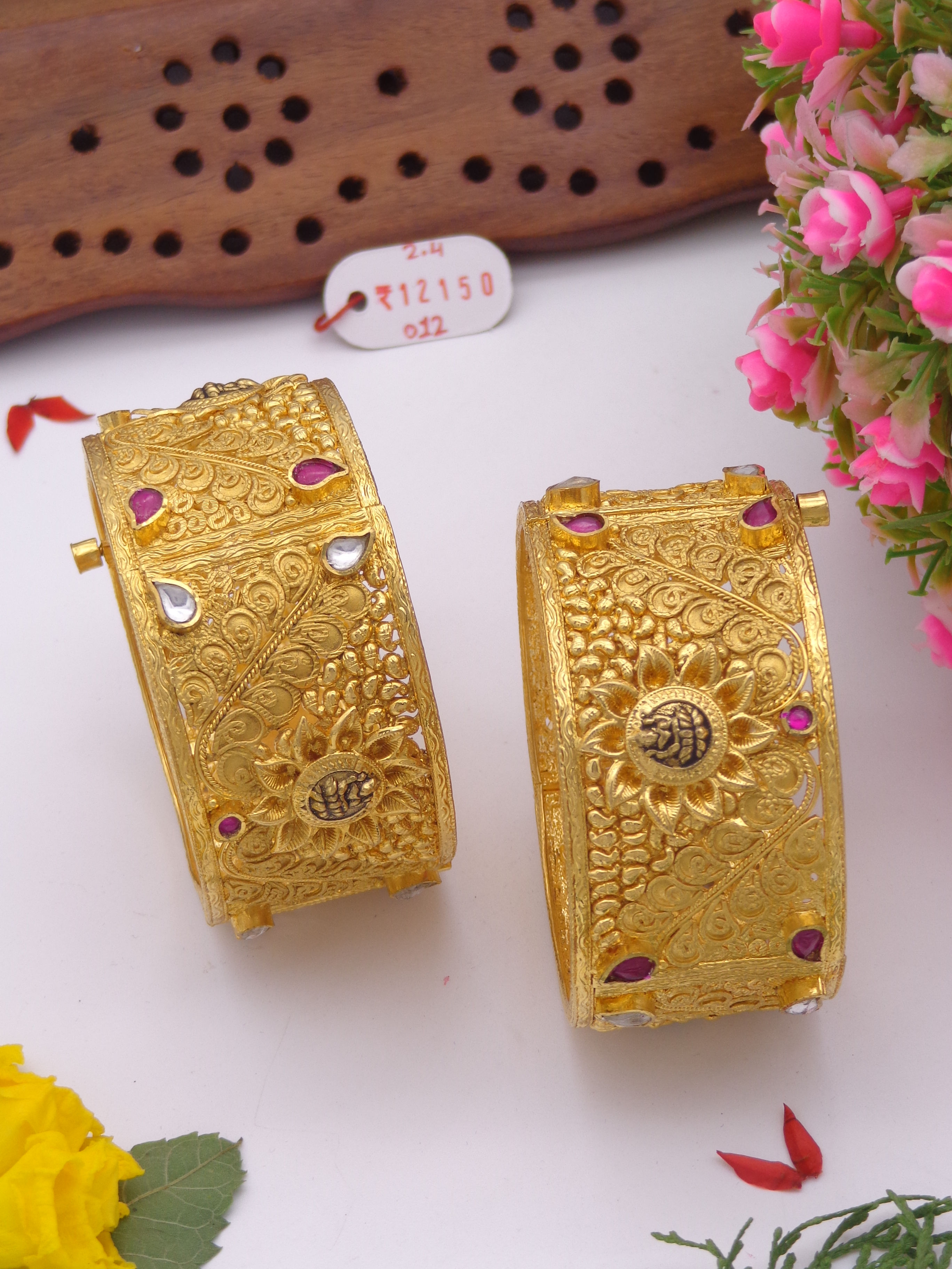 Gold bangles with red and white stones
