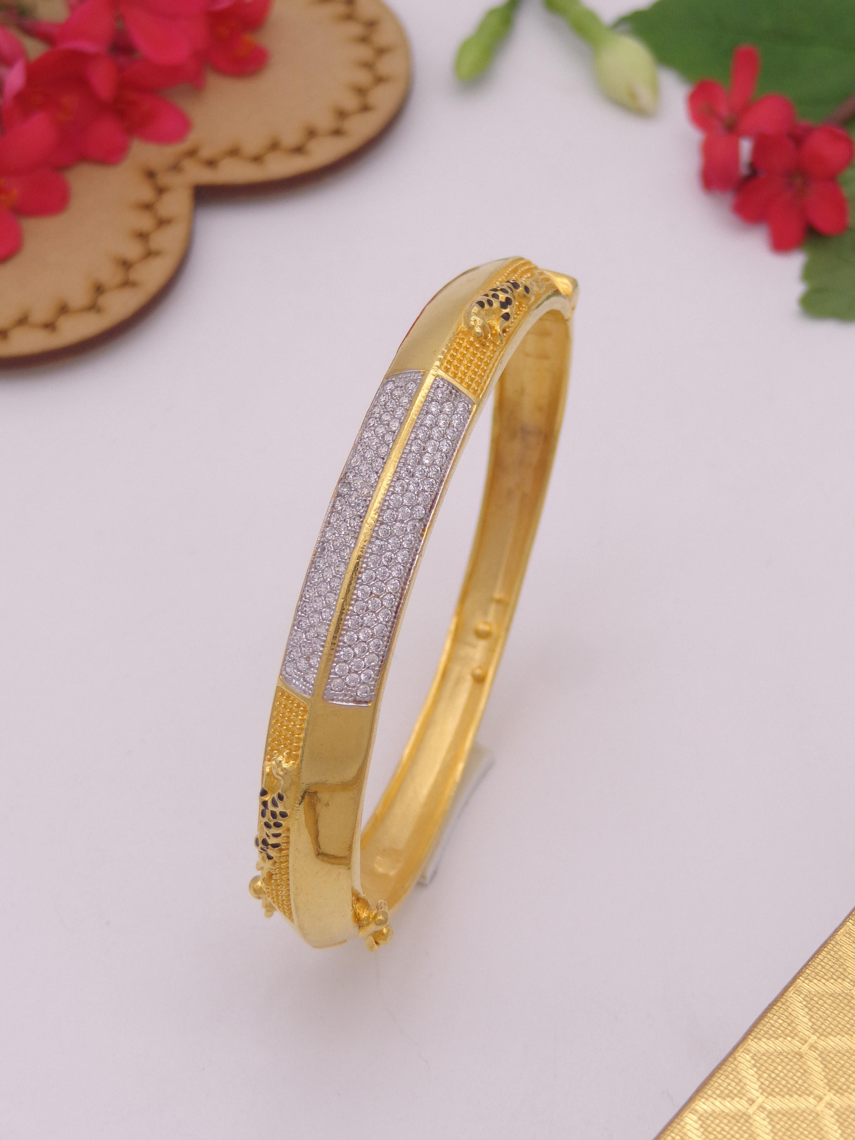 Gold bangle with white stones