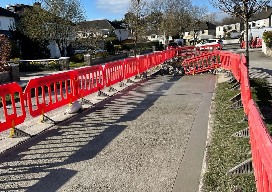 Footpath resurfacing works in progress with safety barriers, local authority works by Formac Construction Leinster