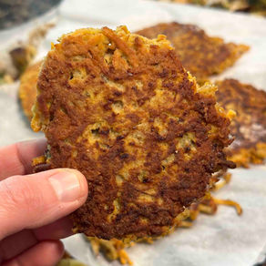 hand holding a homemade sweet potato hash brown fritter