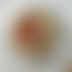 top view of a plate of gluten free funnel cake, topped with coconut vanilla ice cream, and sliced strawberries