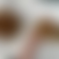 hand holding a slice of banana coffee cake over the square tray of banana coffee cake