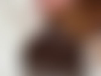 hand dipping whole almond into homemade dark & creamy chocolate hazelnut Nutella spread