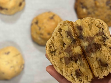 hand holding chunky broke NYC cookie cut in half