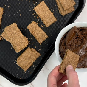 top view of rectangular homemade specuulos biscoff cookies, and bowl of cookie butter dip