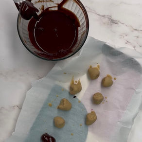 blueberry stuffed raspberries dipped in white chocolate, being dipped in dark chocolate to make homemade tru fry