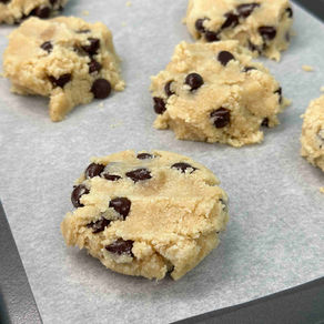 gluten free dairy free vegan chocolate chip cookie dough on a parchment lined baking sheet