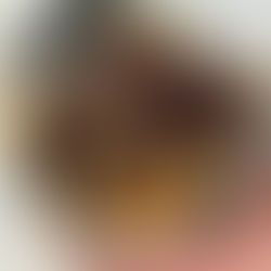 a white bowl stacked full of chocolate covered butterfinger cornflake peanut butter balls