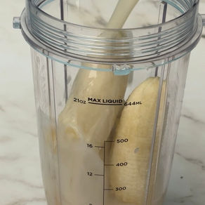 blender jar with bananas and oat milk