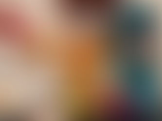 box of brightly coloured gluten free dinosaur shade frozen chicken nuggets, with a hand holding one pterodactyl shaped nugget in front