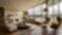 Warm country style living room with a neutral sectional sofa, wood flooring, woven pendant lights, round coffee table, leather lounge chairs, soft textiles, and large curved glass windows.
