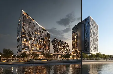 The same three high-rise buildings near the waterfront, shown at dusk with building lights illuminated.