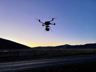 Drone flying low over terrain to capture cinematic tracking shot