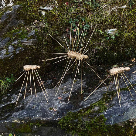 Three bronze sculptures by sculptor Gerhard Petzl. "Three giant ants" are walking over rocky roads.
