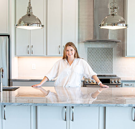 Melissa Wilks, Eastern NC interior designer, posing in a custom home kitchen she designed.