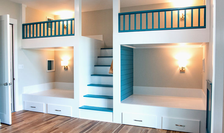 Custom built-in bunk beds with integrated stairs, storage drawers, and painted railings.