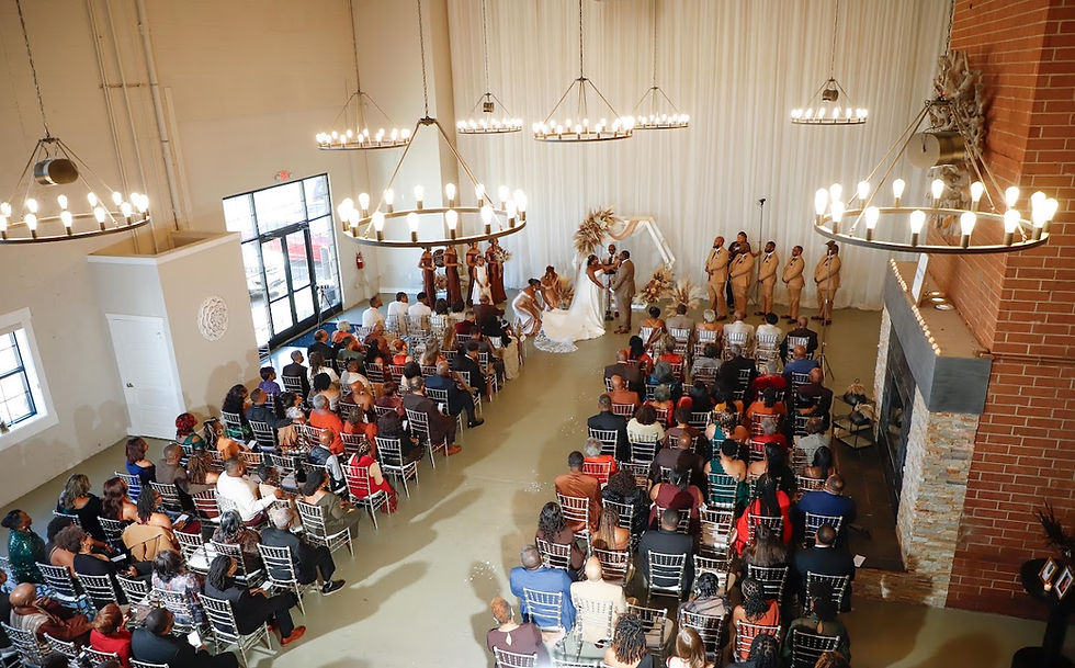 200 wedding guests are seated at an elegant wedding ceremony watching the bride & groom exchange vows