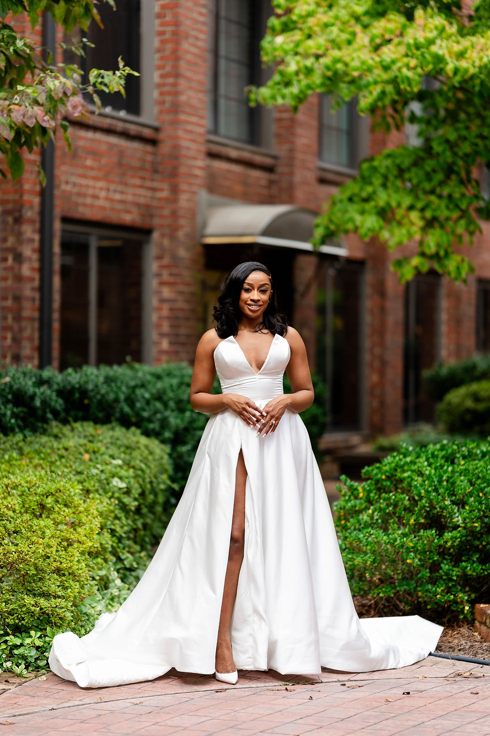 Our beautiful bride posing for wedding day photos at the outdoor garden courtyard at The Event at Two Ten for weddings near Greensboro NC