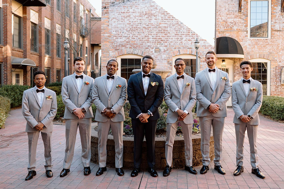 Groom and groomsmen pose for photos at a Winston Salem wedding venue