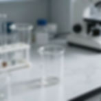 Glass beaker in a lab for regulatory compliance consulting