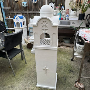 1.3 meter white Greek Orthodox roadside shrine with lit pedestal base outdoors in Melbourne