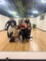 Dancers and their teacher posing for a photo at the end of class