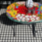 Colorful floral table on checkered floor