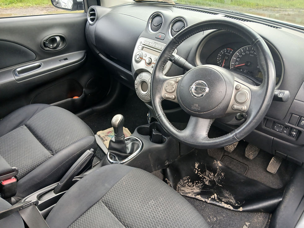 Thumbnail: Nissan Micra interior: black leather seats, manual gear stick