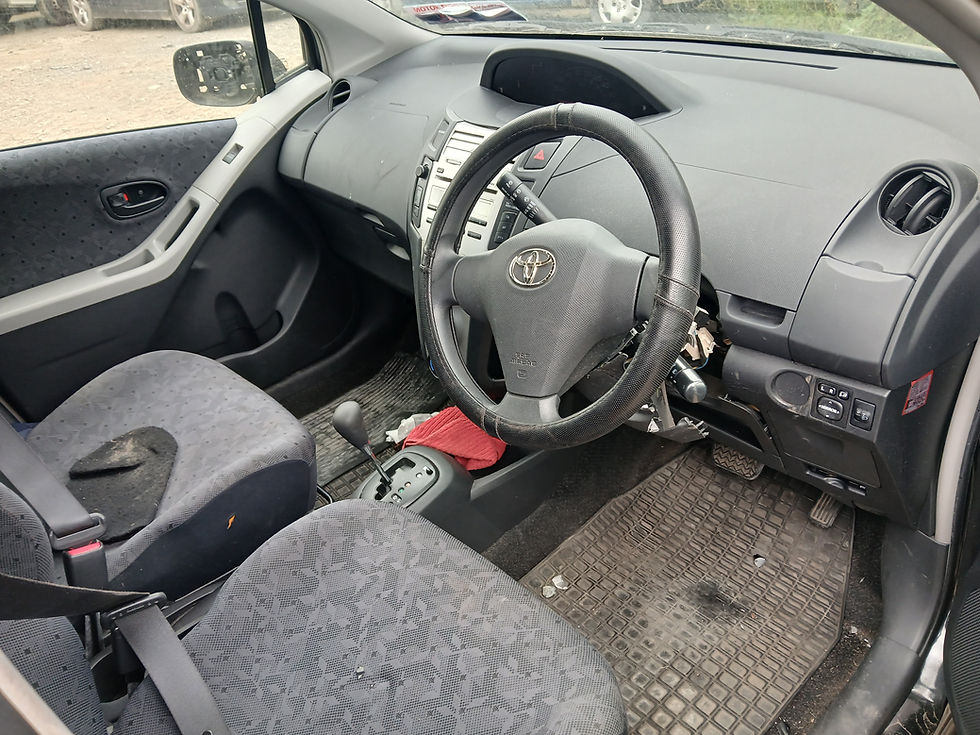 Thumbnail: Toyota Vitz interior: clean, gray seats, steering wheel