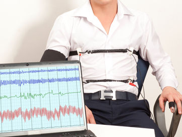 A man strapped into a lie detecting machine